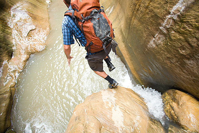 Dave Littman jumps into a pools of water in Orderville Canyon, Zion National Park
