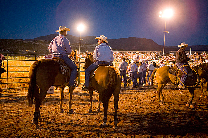 Cowboys watching the show at the Iron County Rodeo, Cedar City, Utah